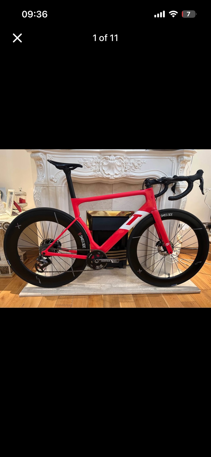 Red 3T Strada road bike with deep-section Swiss Side wheels, drive-side view