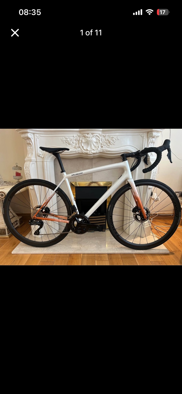 White and copper Specialized Aethos road bike, drive-side view